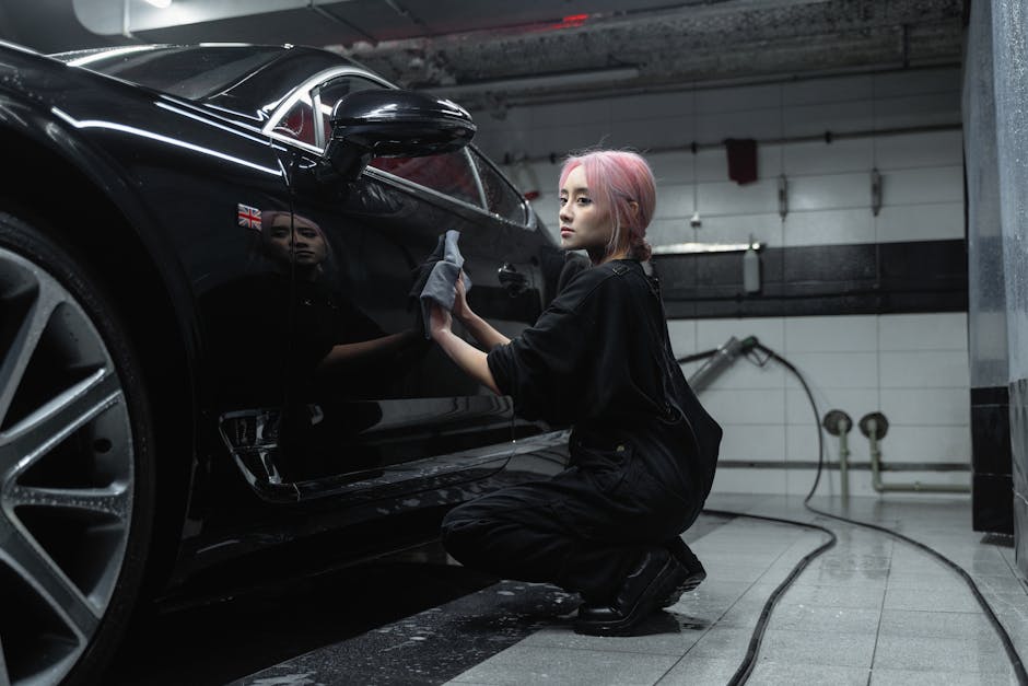 Smiling auto detailing professional inspecting a clean vehicle